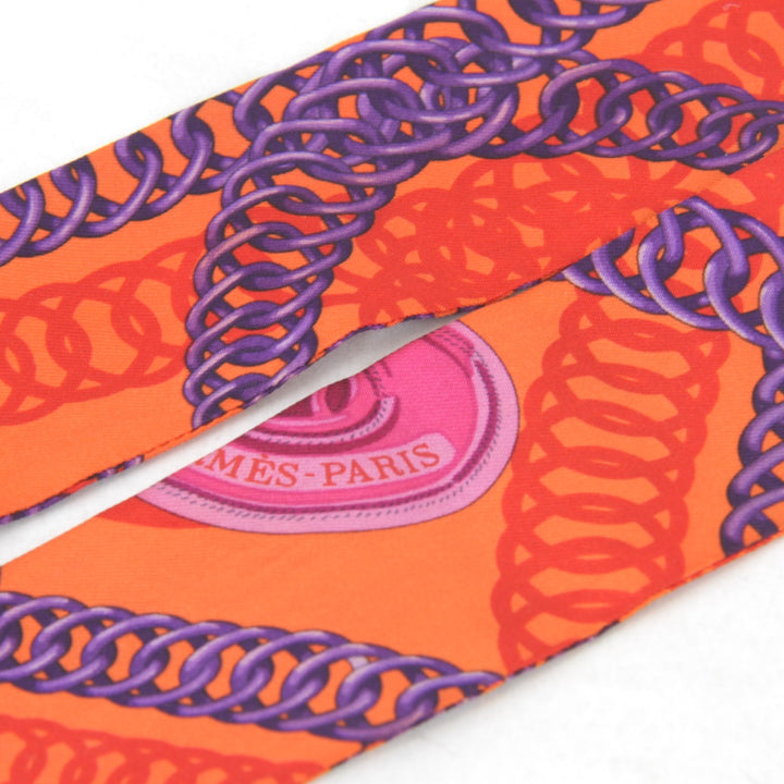 美品『USED』 
HERMES エルメス 
 ツイリー チェーン柄 スカーフ 
シルク オレンジ ビビッドカラー